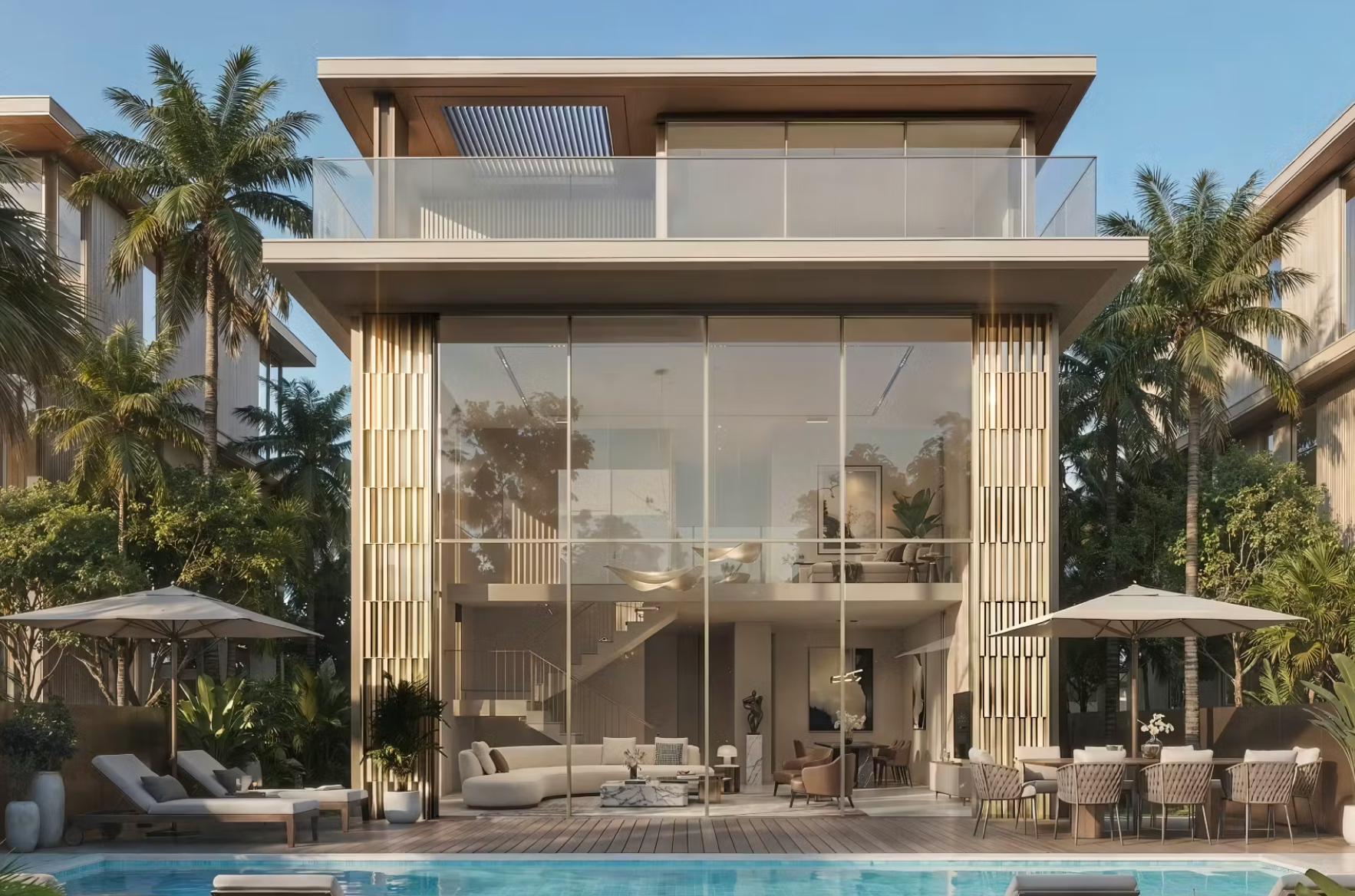 Modern house with large glass windows, outdoor furniture, and pool area.
