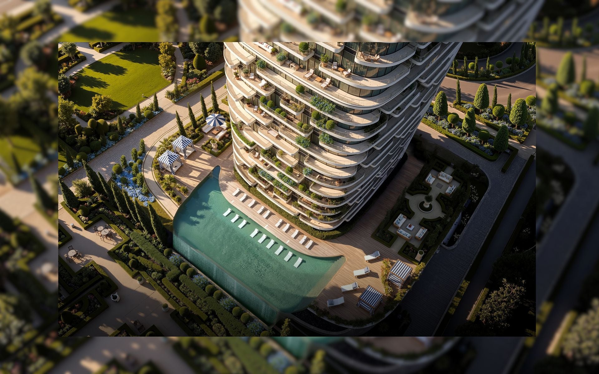 Aerial view of a modern building with a pool surrounded by greenery