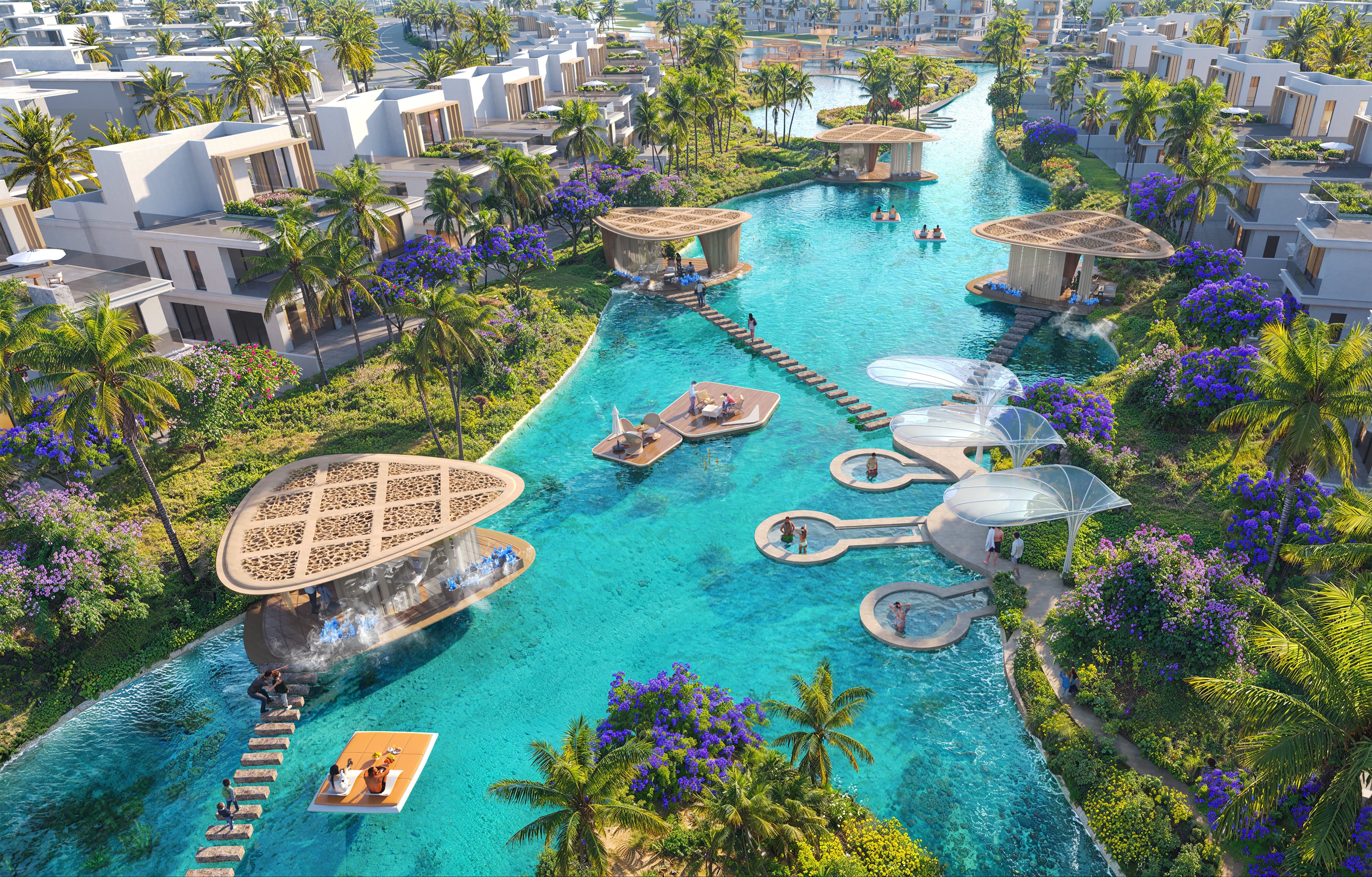 Aerial view of a luxurious resort with a large pool surrounded by palm trees and buildings.