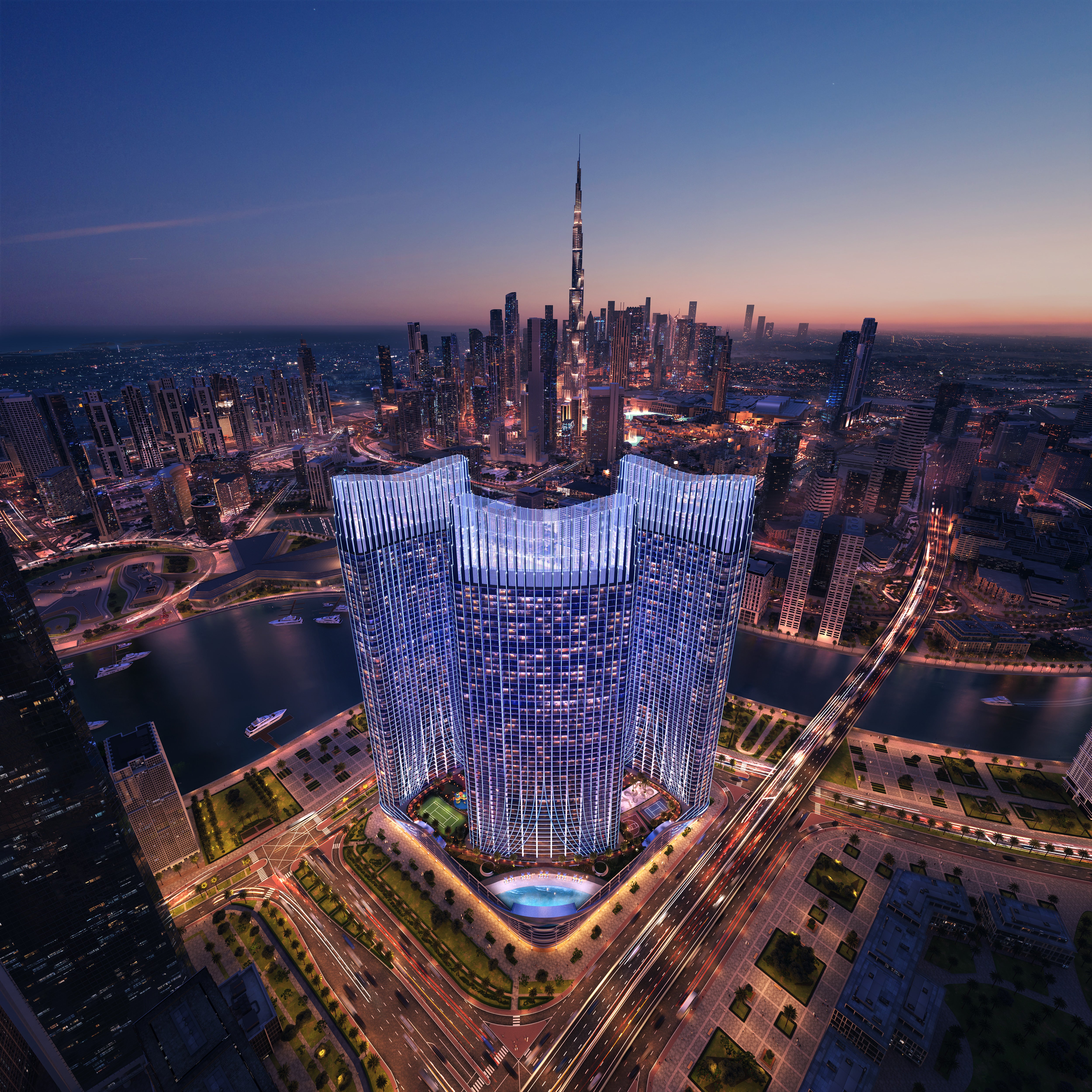 Aerial view of a Binghatti Skyrise skyscraper with a prominent illuminated building at dusk.