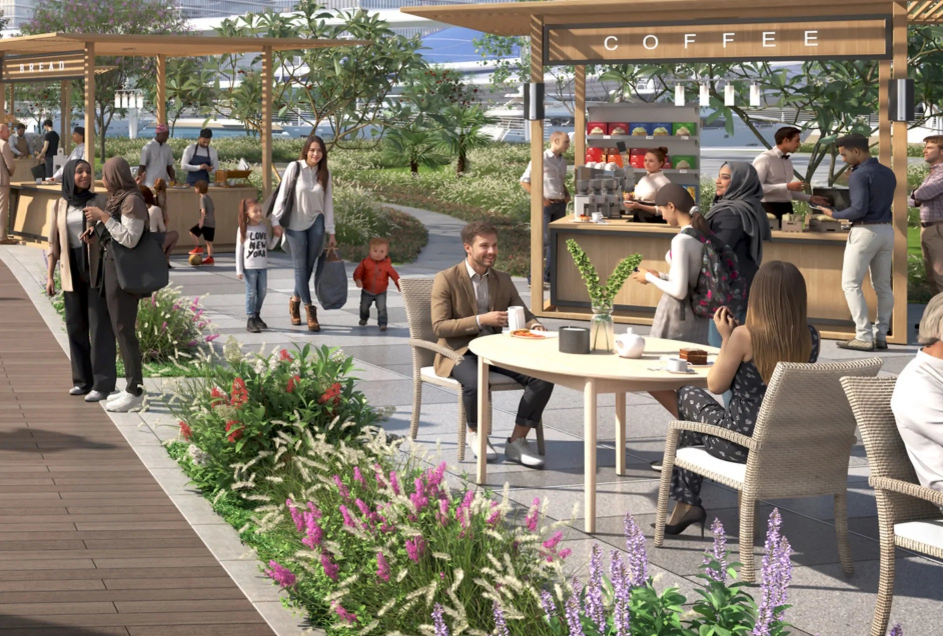 Outdoor café with people sitting and walking, surrounded by greenery and flowers.